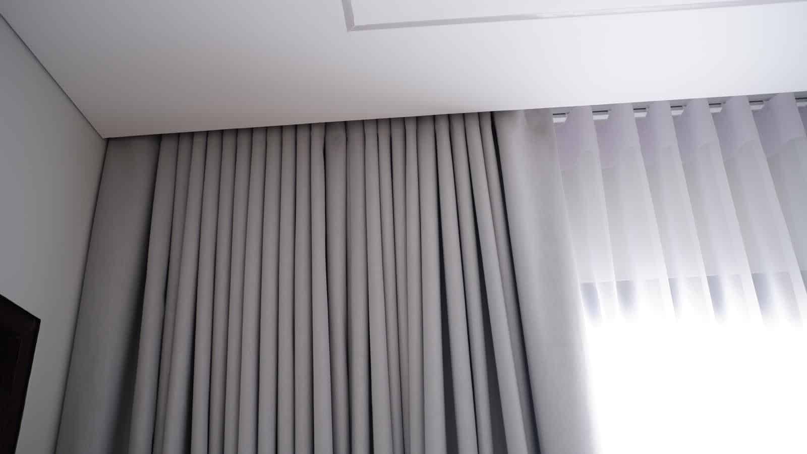 Layered day and night curtains in a Singapore bedroom